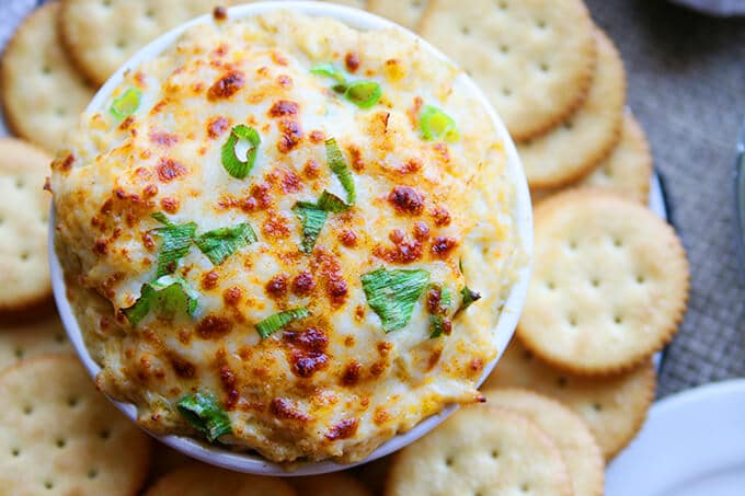 close up picture of crab dip and crackers on a plate