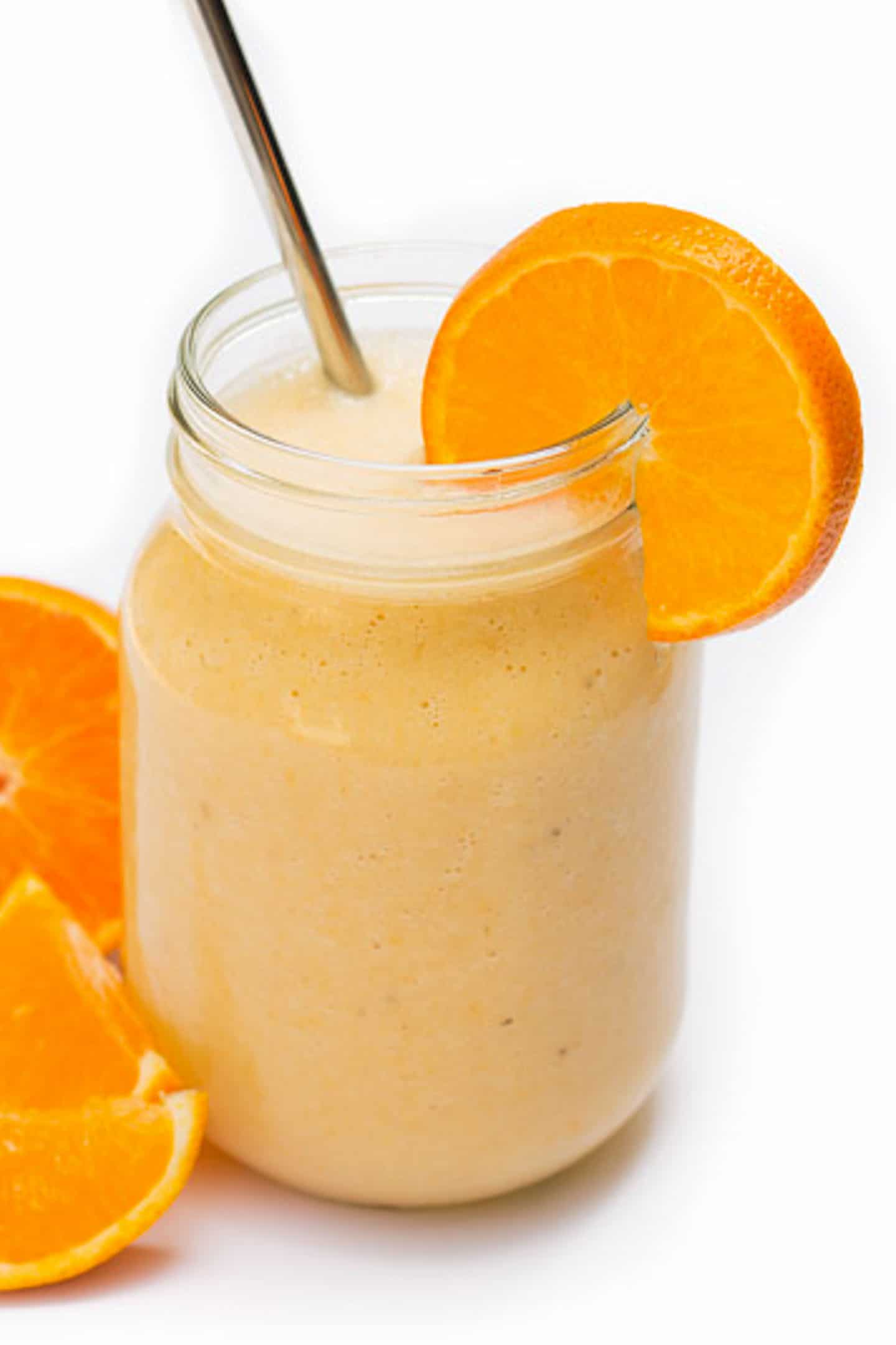Orange Banana Smoothie with a metal straw.