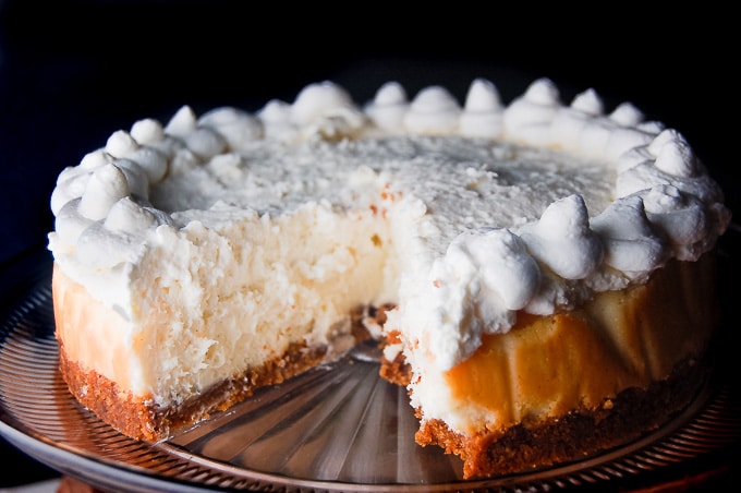 Vanilla Bean Cheesecake with White Chocolate Mousse on a cake stand.