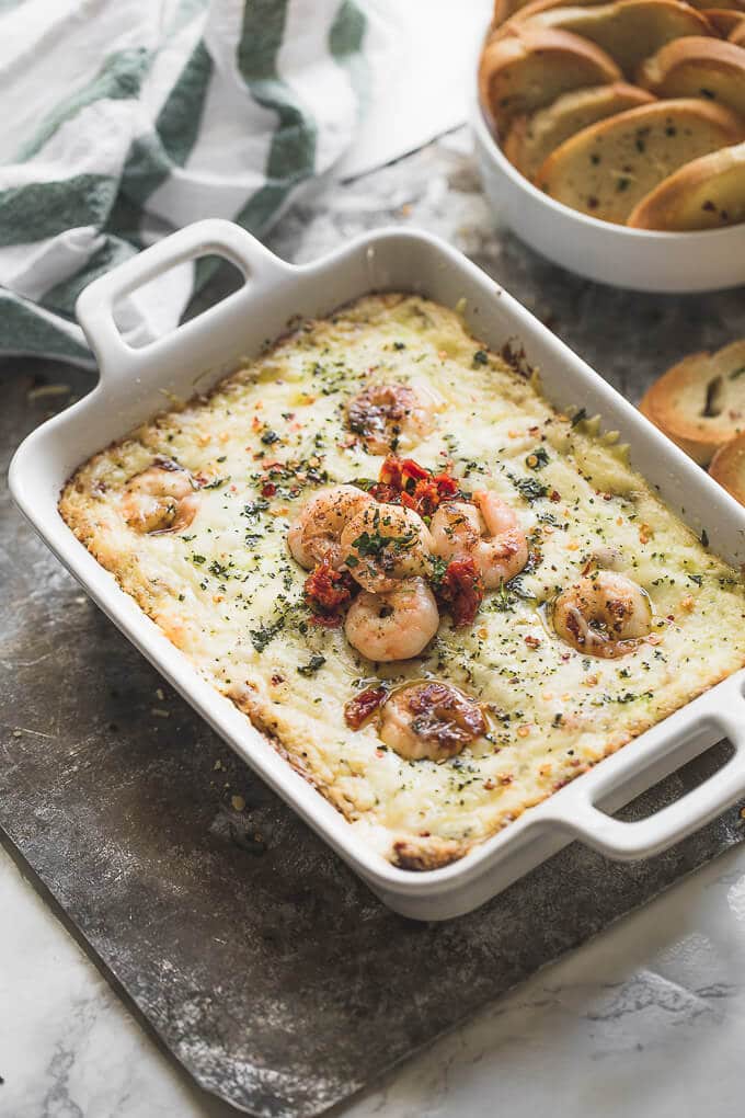 Baked garlic butter shrimp dip in a casserole dish.