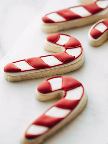 candy cane sugar cookies on a piece of parchment.