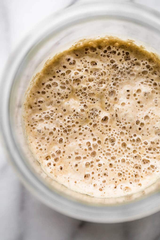 Sourdough starter with lots of bubbles on top.