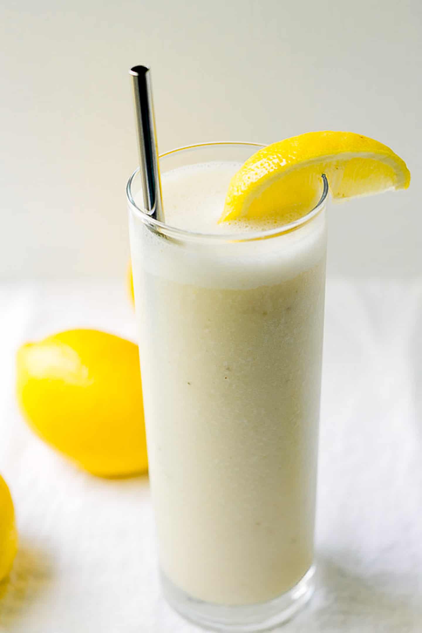 Lemonade Crush smoothie in a glass with lemons.