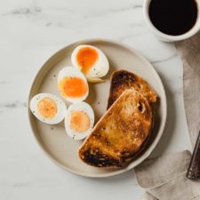 soft boiled eggs and hard boiled eggs on a plate with toast