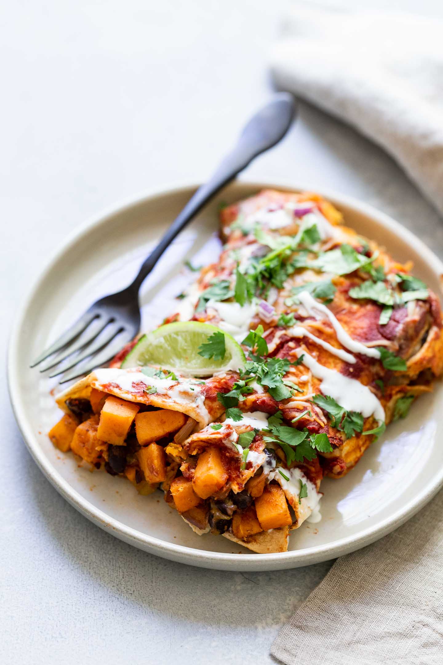 A serving of sweet potato enchiladas on a plate.