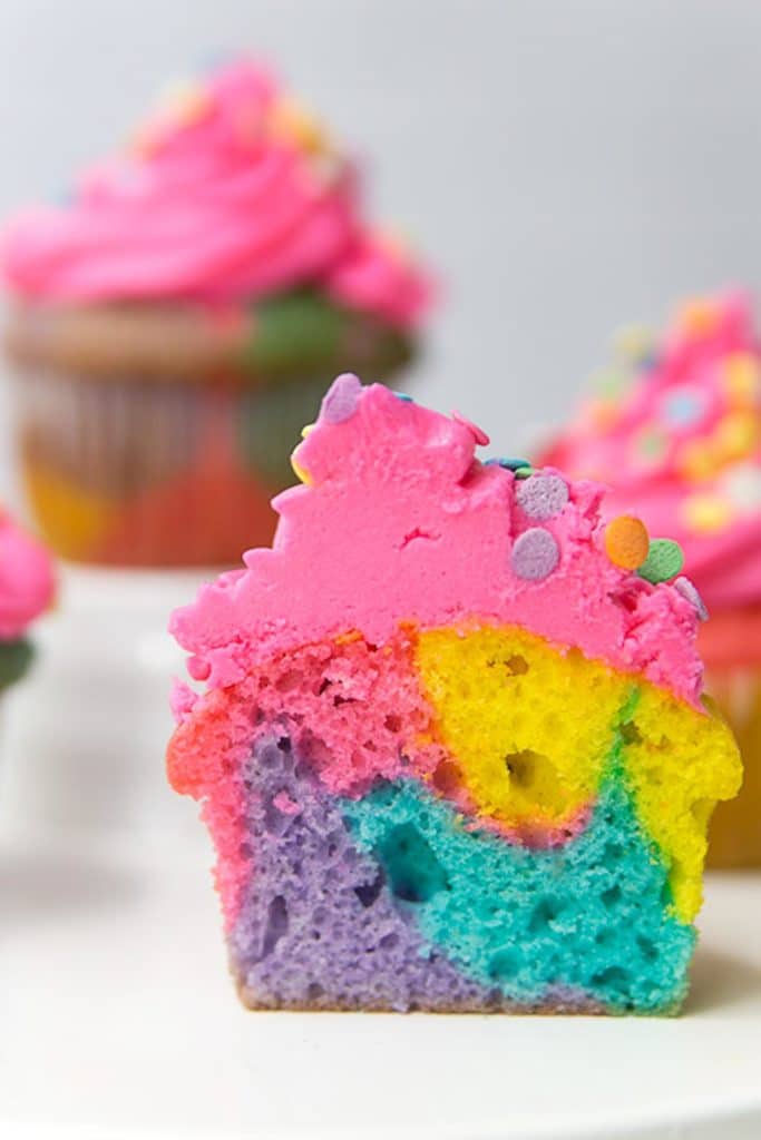 A rainbow marble cut in half to see the inside of the cupcake