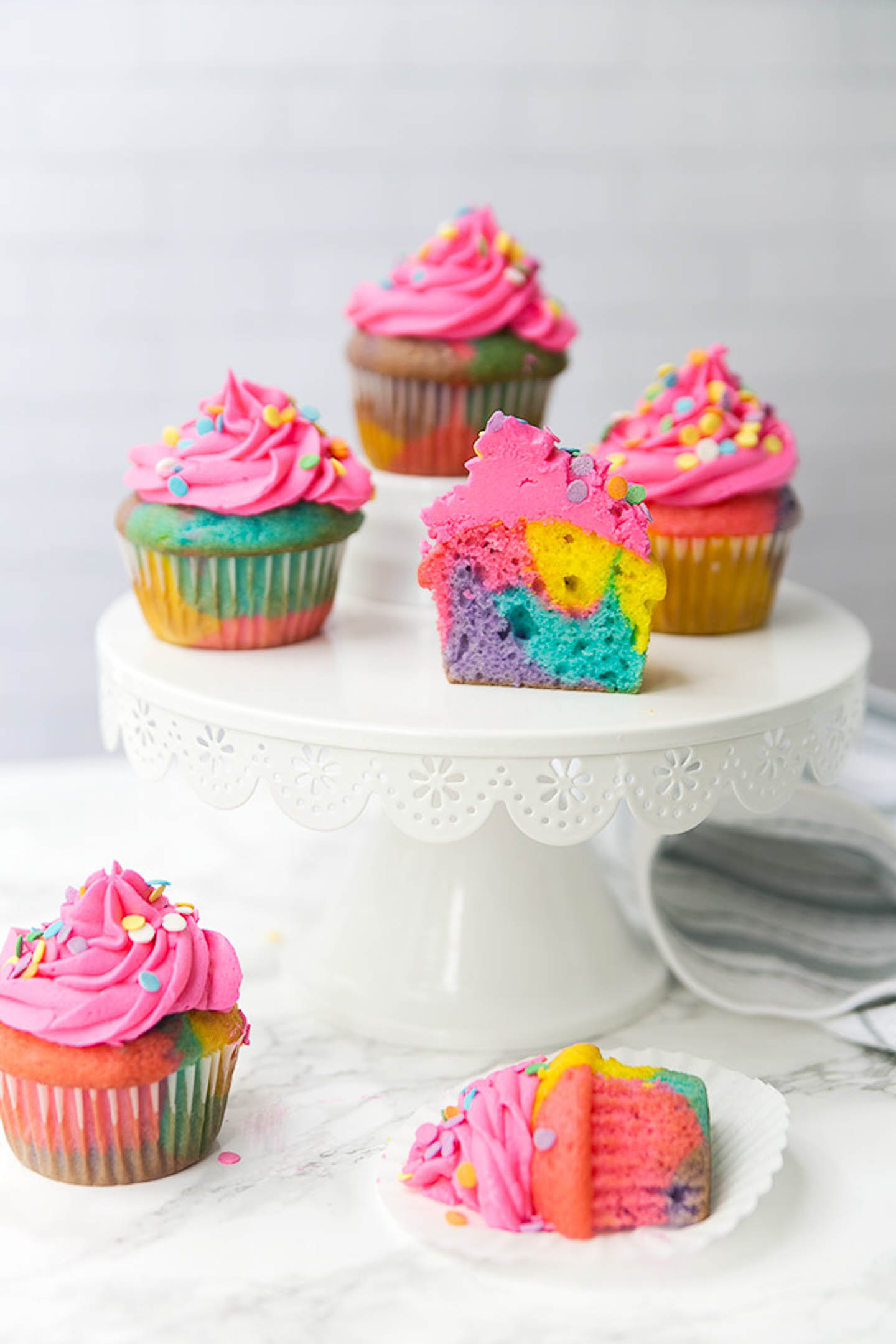 Rainbow marble cupcakes on a cakestand.