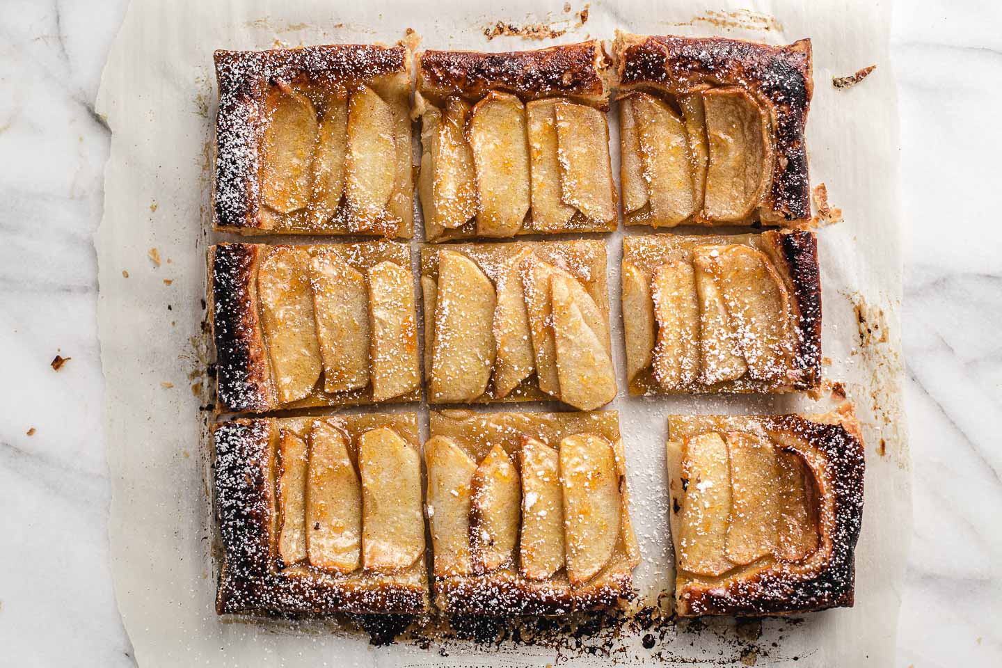 Apple tart cut into nine squares.