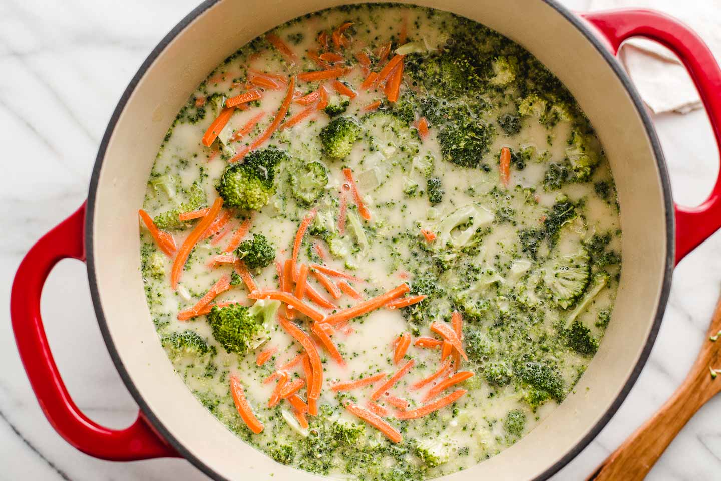 Broccoli cheddar soup ingredients in a stockpot.