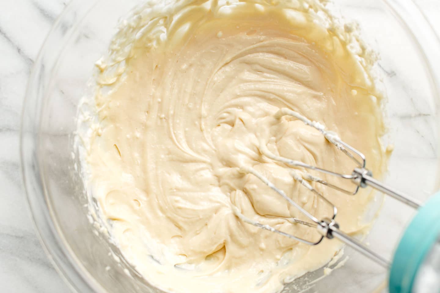 Cream cheese frosting in a mixing bowl.