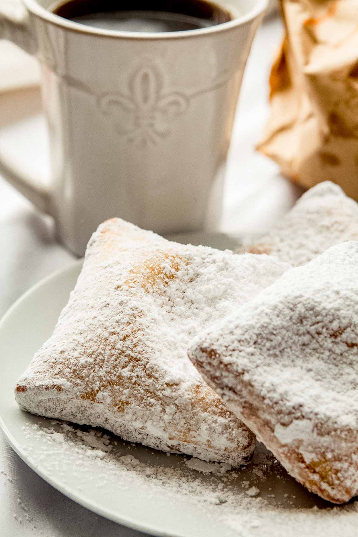3 New Orleans style beignets on a plate.