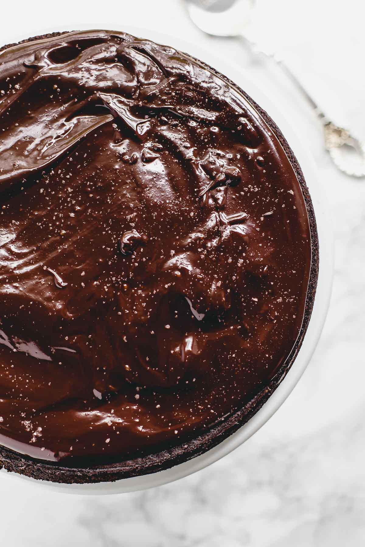 Flourless chocolate cake on a serving platter.