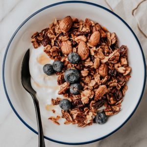 Granola and fresh blueberries in a bowl with yogurt.