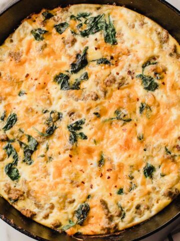 Turkey sausage and spinach frittata in a cast iron skillet.
