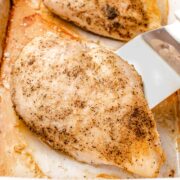 Baked chicken breast in a pan.