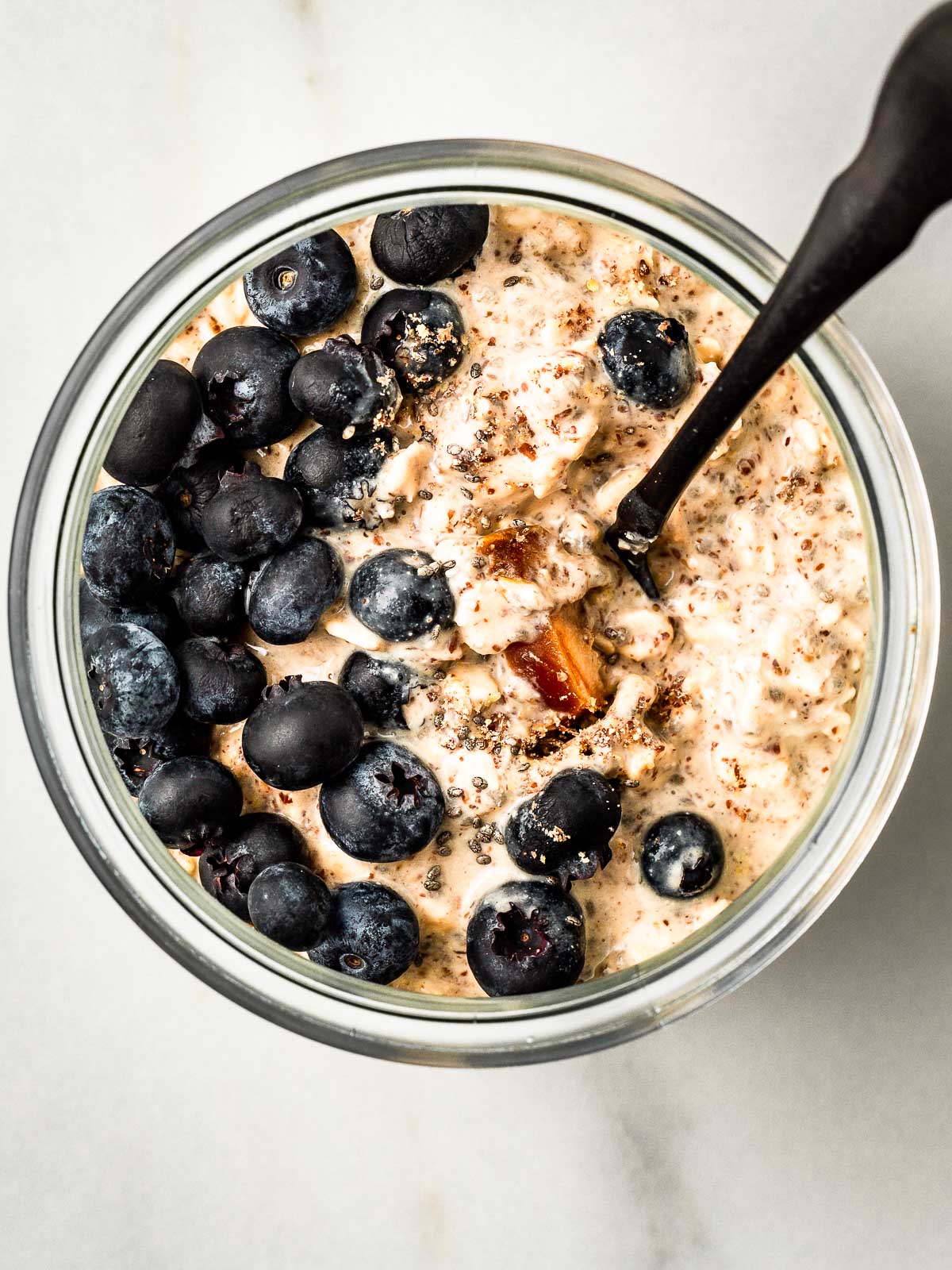 Overnights oats with blueberries and dates in a jar.
