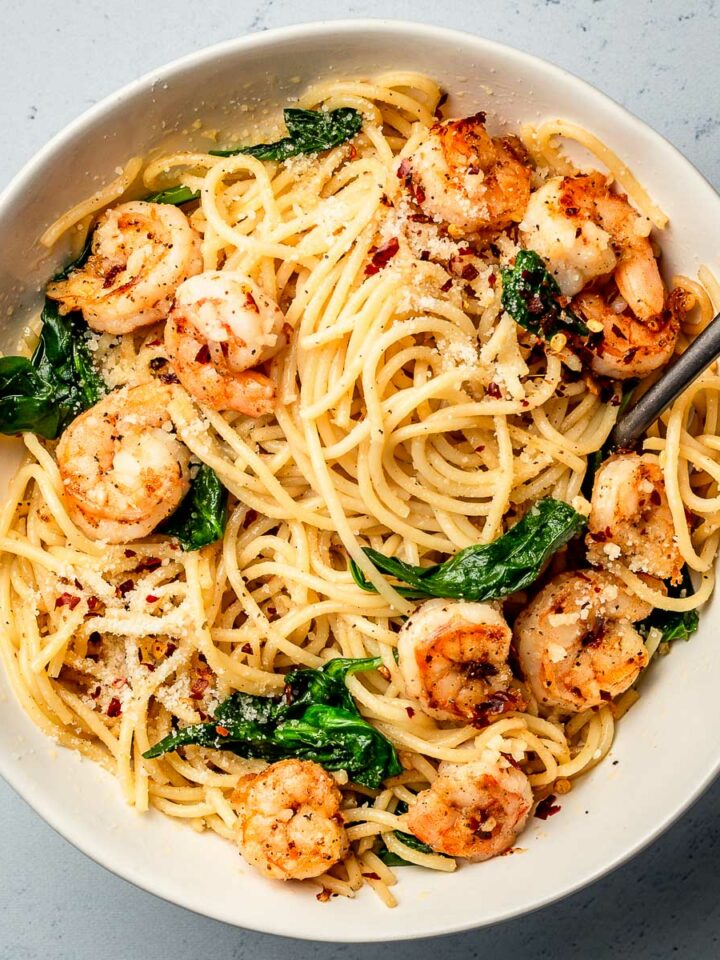 A bowl of pasta with garlic butter shrimp.