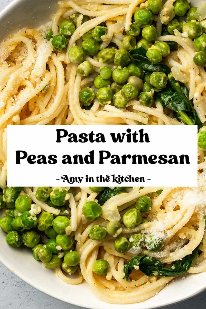 A bowl with pasta, peas, parmesan and lemon with a fork.