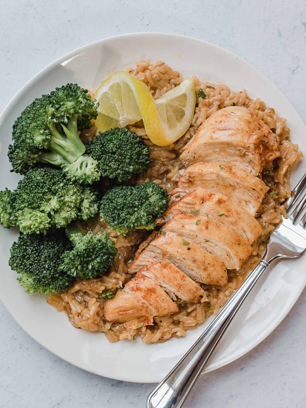 IP Lemon Herb Chicken and Rice on a plate with broccoli.