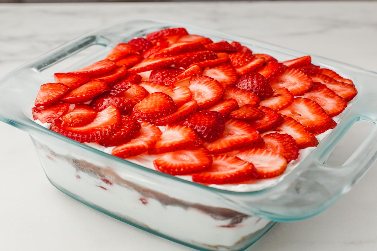 A baking dish with the finished strawberry icebox cake.