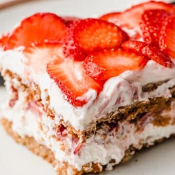 A closeup photo of a slice of gluten-free strawberry icebox cake.