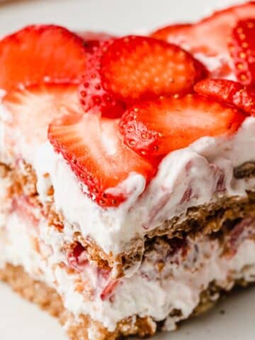 A closeup photo of a slice of gluten-free strawberry icebox cake.